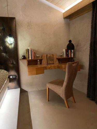a desk in a room with a chair and a table at Micro-lodge, Jardin Secret in Montriond