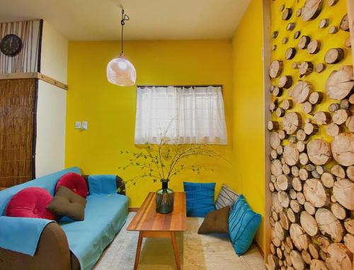 a living room with a blue couch and a table at Lucy's House横浜中華街 House5 in Yokohama