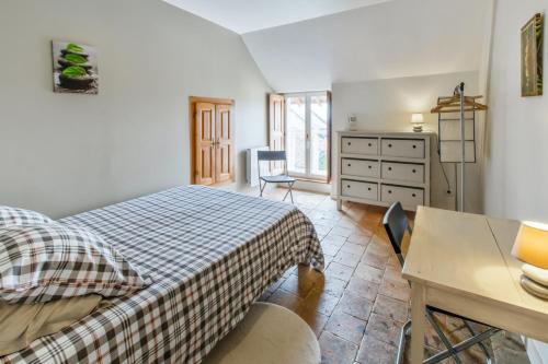 a bedroom with a bed and a desk and a dresser at Maison spacieuse à Assay avec jardin et cheminée in Assay