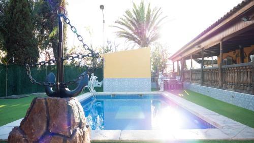 a swimming pool in a yard next to a house at Elegant Villa in Archena + Private Pool in Archena