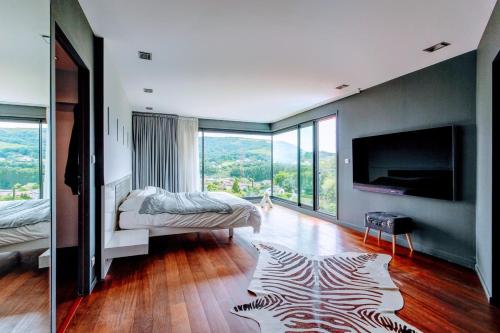 a bedroom with a zebra rug on a wooden floor at Villa de 4 chambres avec piscine privee jacuzzi et jardin amenage a Saint Desirat in Saint-Désirat