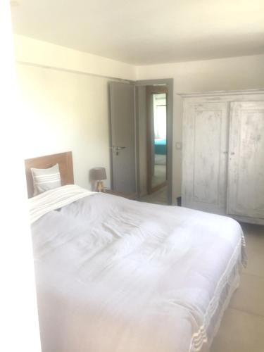 a white bed in a white bedroom with a window at Heavenly Villa in Gustavia with Private Pool in Gustavia