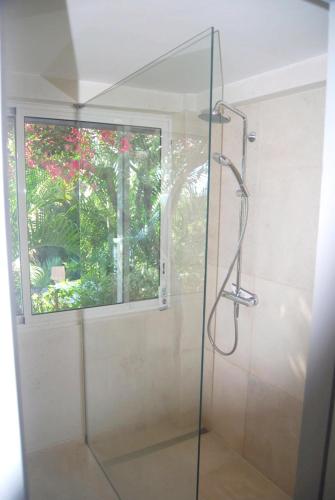 a glass shower in a bathroom with a window at Heavenly Villa in Gustavia with Private Pool in Gustavia