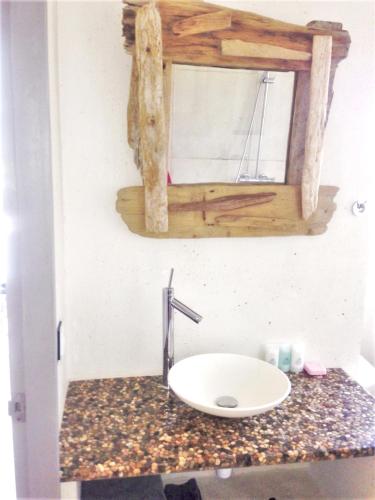 a bathroom with a sink and a mirror on a counter at Heavenly Villa in Gustavia with Private Pool in Gustavia