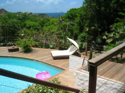 a swimming pool on a wooden deck next to at Heavenly Villa in Gustavia with Private Pool in Gustavia