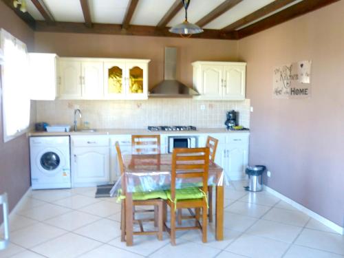 a kitchen with a table and chairs and a sink at Maison de 2 chambres avec jardin clos a Cilaos in Cilaos