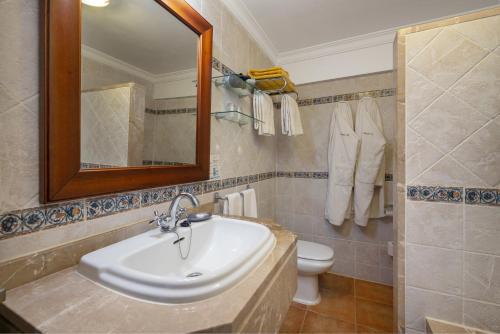 a bathroom with a sink and a toilet and a mirror at Monnaber Nou Finca Hotel & Spa in Campanet