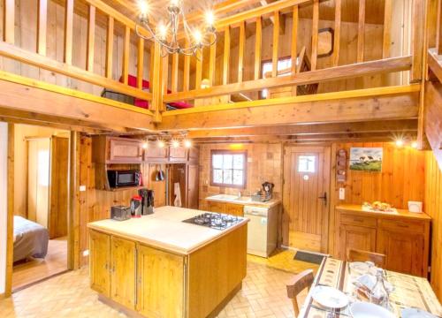 a large kitchen with wooden walls and wooden cabinets at Chalet de 2 chambres avec terrasse amenagee et wifi a Saint Gervais les Bains a 3 km des pistes in Saint-Gervais-les-Bains