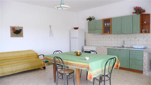 a kitchen with a table and chairs in a room at 4 bedrooms house with furnished terrace and wifi at Marinella di Selinunte 1 km away from the beach in Marinella di Selinunte