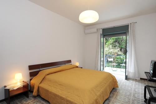 a bedroom with a bed and a large window at One bedroom apartement at Maiori 50 m away from the beach with furnished balcony and wifi in Maiori