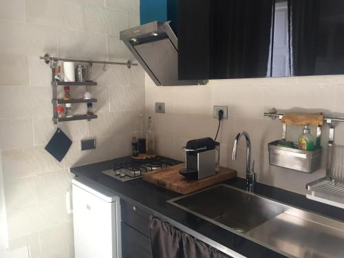 a kitchen with a sink and a stove at Studio with furnished balcony and wifi at Pisticci in Pisticci