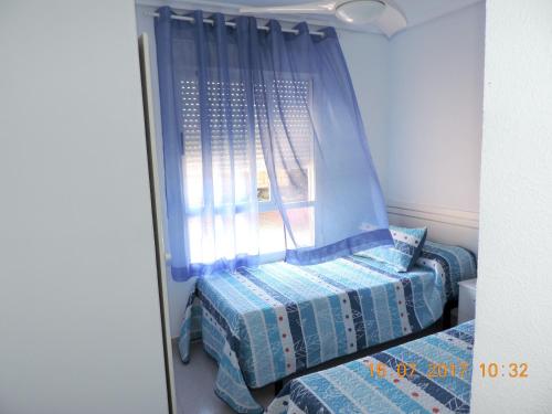 Katil atau katil-katil dalam bilik di Cozy Apartment in Dénia
