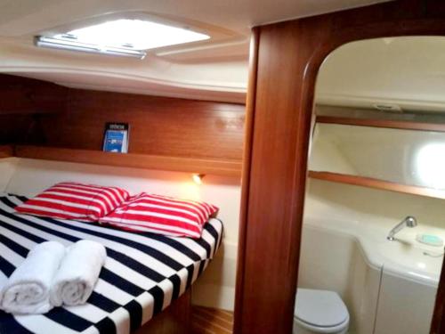a small boat with a bed and a bath tub at Charming Boat in Funchal with Sea View in Funchal