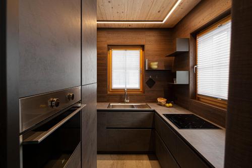a kitchen with a sink and a counter top at Chalet Cirmolo in Livigno