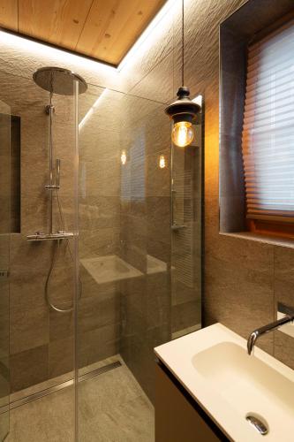 a bathroom with a shower and a sink at Chalet Cirmolo in Livigno