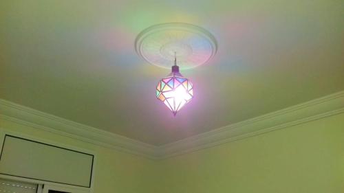 a pink light hanging from a ceiling in a room at Charming Apartment in Mirleft with Balcony and Parking. in Mirleft