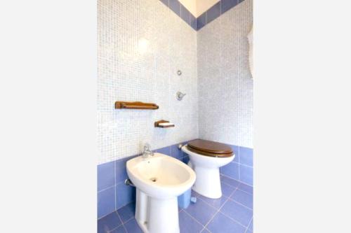 a bathroom with a toilet and a sink at 5 bedrooms apartement with sea view shared pool and enclosed garden at Marsala 5 km away from the beach in Marsala
