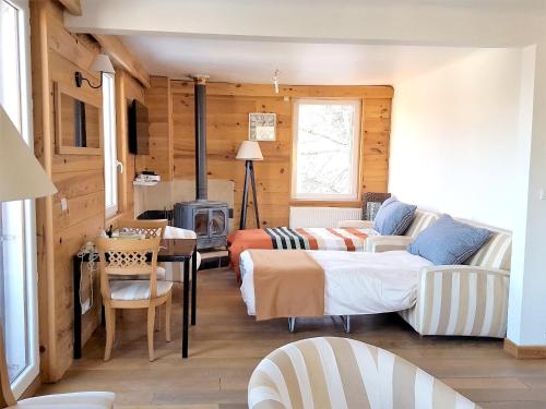 a living room with a bed and a couch at Appartement de 3 chambres avec jardin clos et wifi a Mont Saxonnex in Mont-Saxonnex