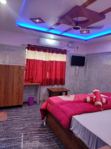 a bedroom with a bed with a teddy bear on it at Aryan residency in Māvalli