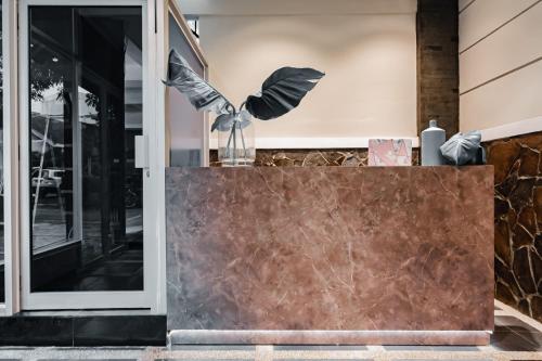 a front door of a building with a marble counter at RedDoorz Plus @ Bagusrangin Street in Bandung