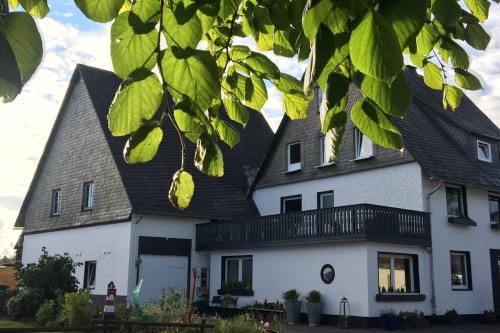 a large white house with a black roof at Gruppenhaus bis zu 24 Personen in Winterberg in Winterberg