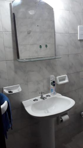 a bathroom with a white sink and a mirror at Hermosa Casita II Paso Patria in Paso de la Patria