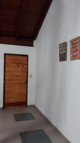 a room with a wooden door and signs on the wall at Hermosa Casita II Paso Patria in Paso de la Patria