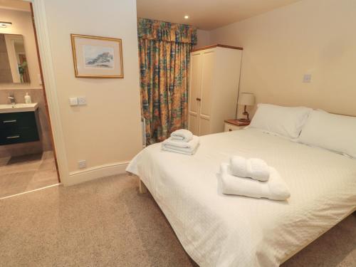a bedroom with a bed with two towels on it at Jackson Cottage in Alnwick