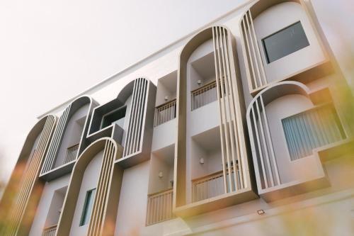 an external view of a building with balconies at Nappiness Hotel - SHA ExtraPlus in Bangkok