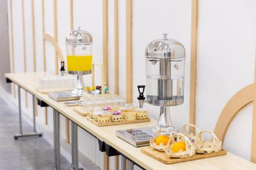 a table with cookies and a food processor on it at Nappiness Hotel - SHA ExtraPlus in Bangkok