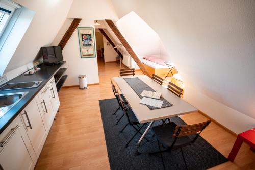 a kitchen and dining room with a table and chairs at Black Forest Bike Hostel in Kirchzarten