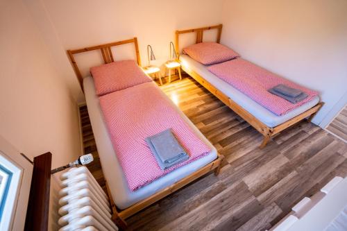 an overhead view of two beds in a room at Black Forest Bike Hostel in Kirchzarten