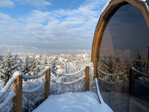 a room with a view of the city in the snow at Osada Na Ochodzitej in Koniaków