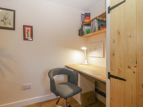 a bedroom with a desk and a chair in a room at The Nest at the Round House in Warminster