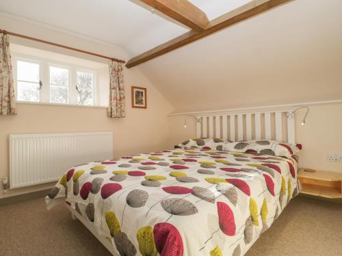 a bedroom with a large bed in a room at The Nest at the Round House in Warminster