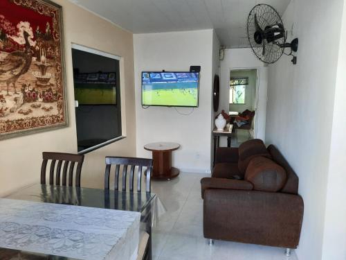 a living room with a couch and a table at BEACH HOUSE ARUANA in Aracaju