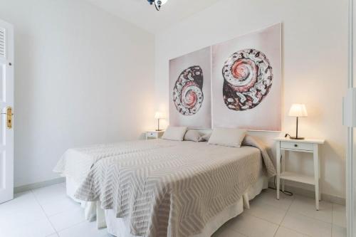 カレタ・デル・セボにあるEl Sombrerito 2のベッドルーム1室(壁に絵画2点が飾られたベッド1台付)