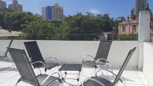 a group of chairs and tables on a balcony at Santos Hotel in Santos