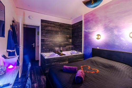 a bedroom with a bed and a bath tub at LOVE ROOM - SPECIAL AMOUREUX - HYPER CENTRE - Lorient in Lorient