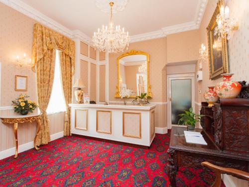a room with a mirror and a red carpet at The Elmington Hotel in Torquay