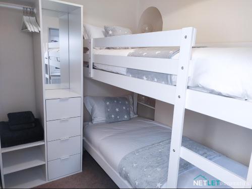 a bedroom with two bunk beds with a mattress at Station Cottage - Gorgeous property with breathtaking views of Neyland Waterway in Neyland