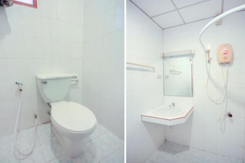 a white bathroom with a toilet and a sink at Ban Elephant Blanc Apartment in Kata Beach