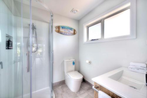 a bathroom with a shower and a toilet and a sink at Archella 1 in Coles Bay