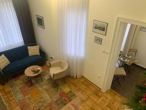 a living room with a blue couch and a chair at Old Town City Center in Belgrade