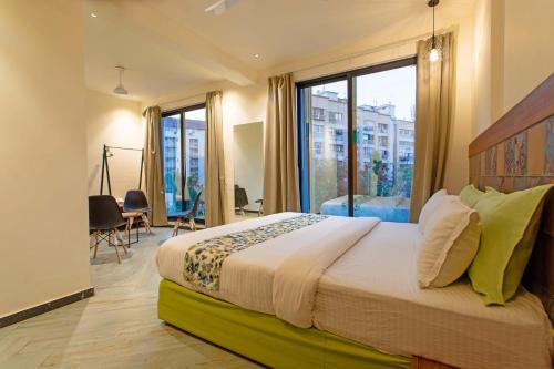 a bedroom with a large bed with a large window at Nova Park in Rajkot