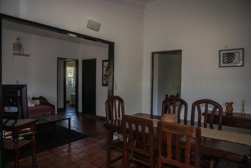 a living room with a dining room table and chairs at Nuevas Cabañas Del Sol in San Lorenzo