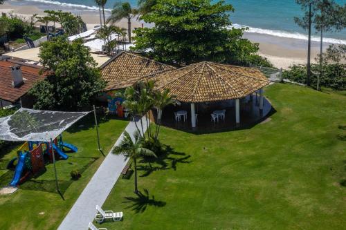 an overhead view of a house with a playground and the beach at Hotel Porto Sol Beach in Florianópolis