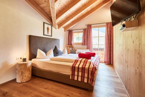 a bedroom with a large bed in a room at Apartchalet Jörglerhof in Gerlos