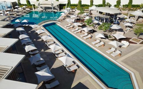 an overhead view of a resort pool with umbrellas and chairs at Sofitel Dubai The Obelisk in Dubai