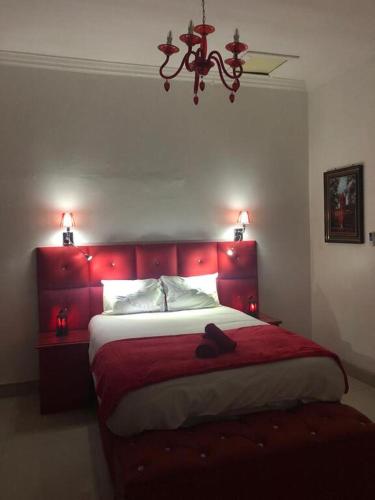 a bedroom with a red bed with a red headboard at Casa 57 in Pietermaritzburg